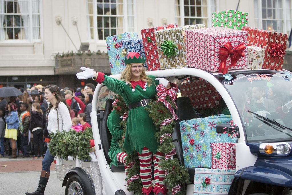 An elf waves from a gift-covered float in the Charleston Holiday Parade